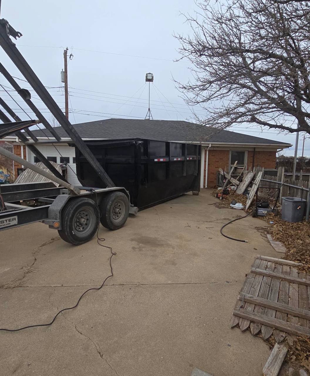 Shifty dumpster rental dropped off in a residential driveway