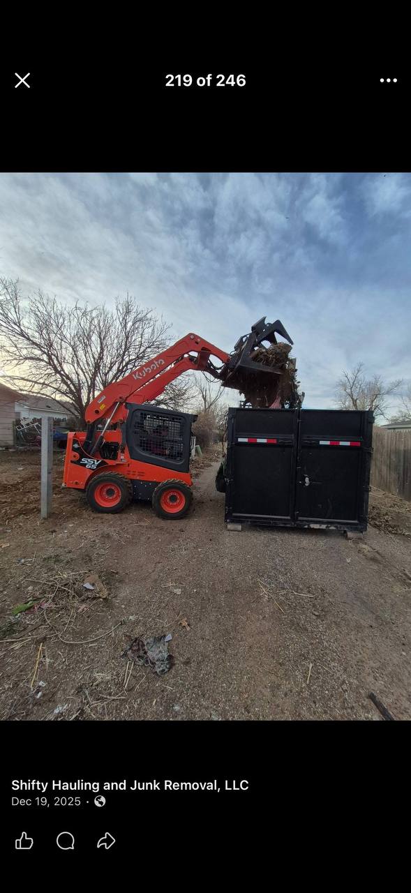 Kubota equipment loading demolition debris into a dumpster